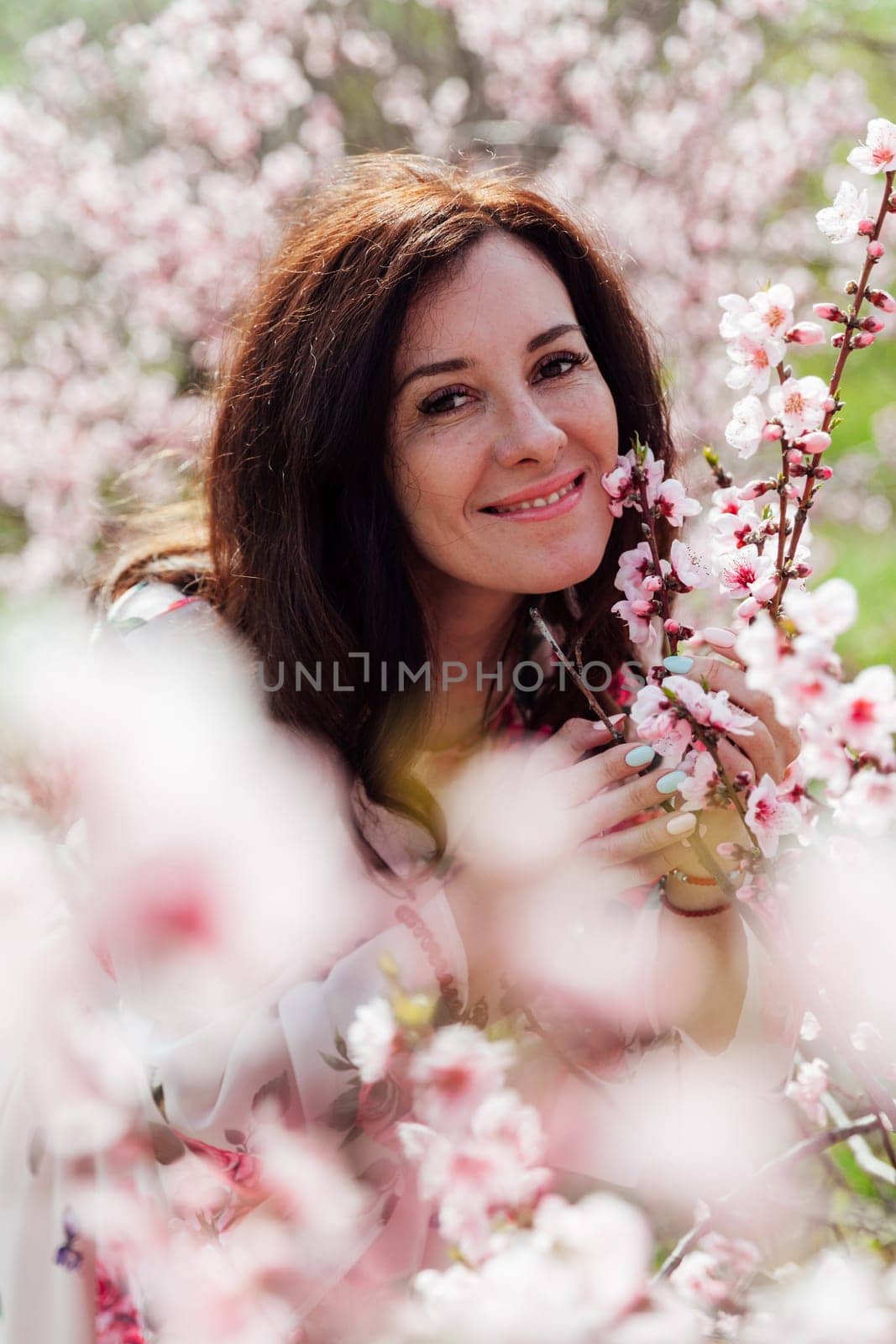 beautiful woman brunette in flowering trees spring nature travel walk by Simakov