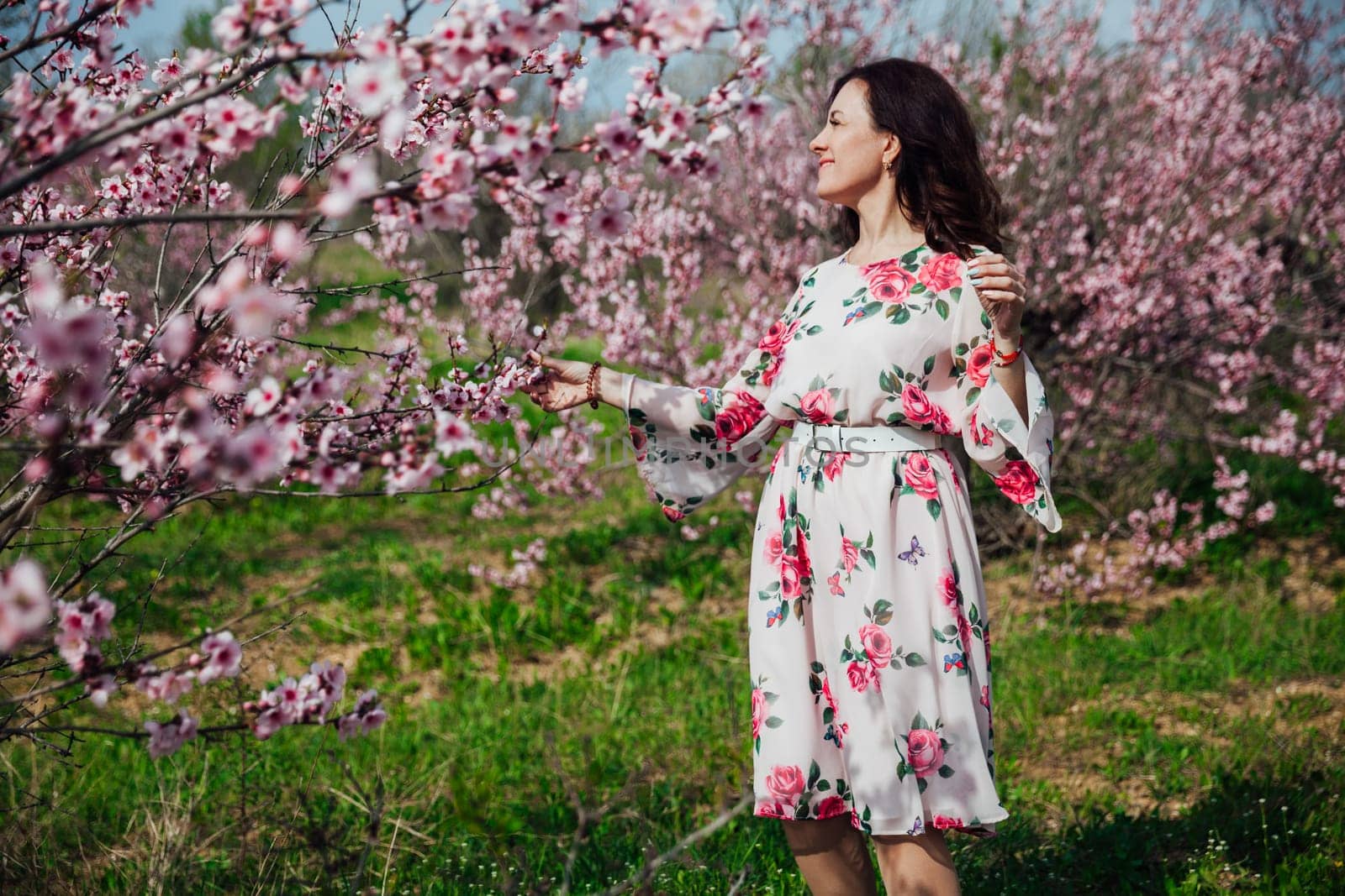 beautiful woman brunette in flowering trees spring nature travel walk by Simakov