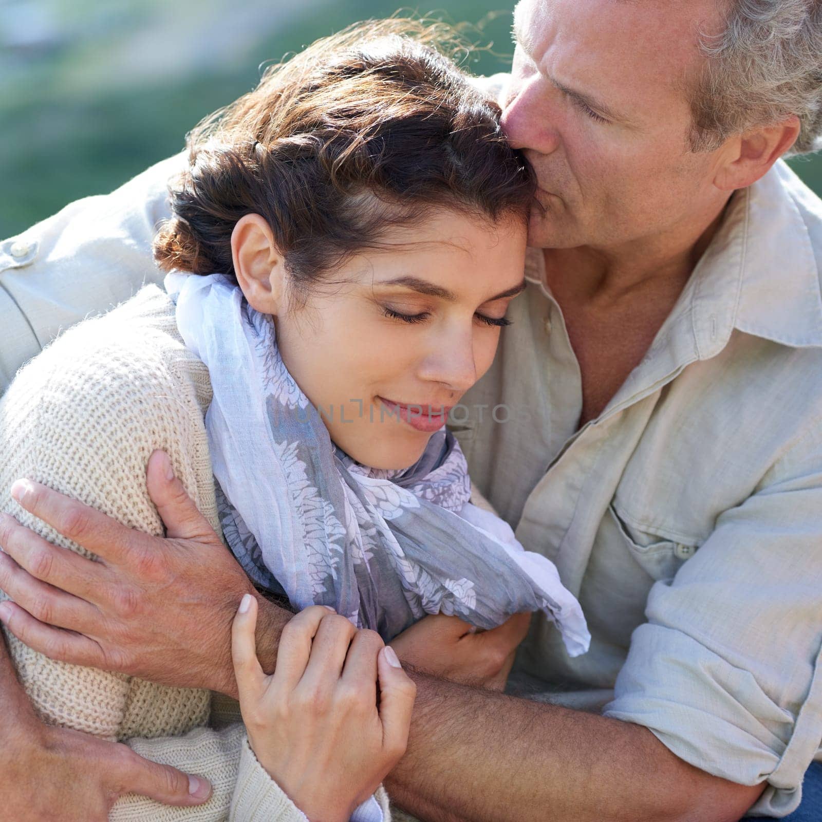 Couple, forehead kiss and hug with love, peace or happy on holiday with gratitude for partnership. Mature, man and woman relax in embrace outdoor on vacation together or show affection and care by YuriArcurs