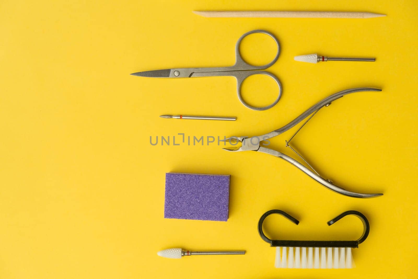 Professional manicure tools on yellow background. Manicure set. by AnatoliiFoto