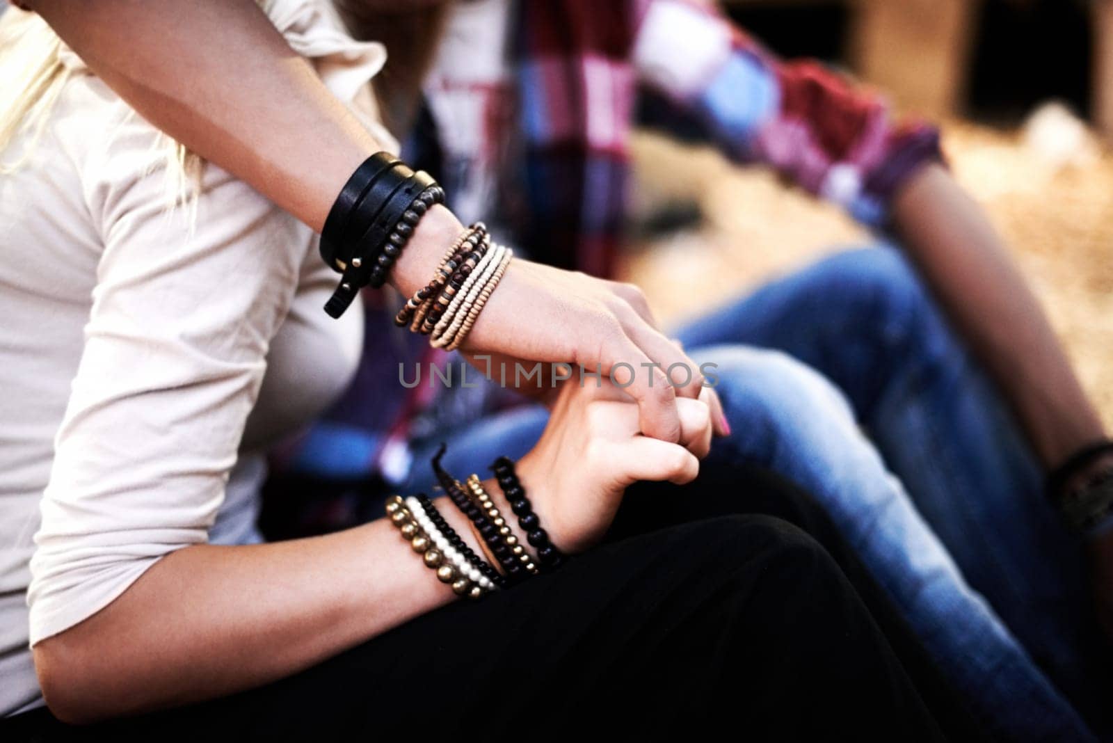 Love, date and a couple holding hands at a music festival outdoor together closeup for romance or bonding. Party, concert or event with a man and woman in the audience or crowd for a carnival show.