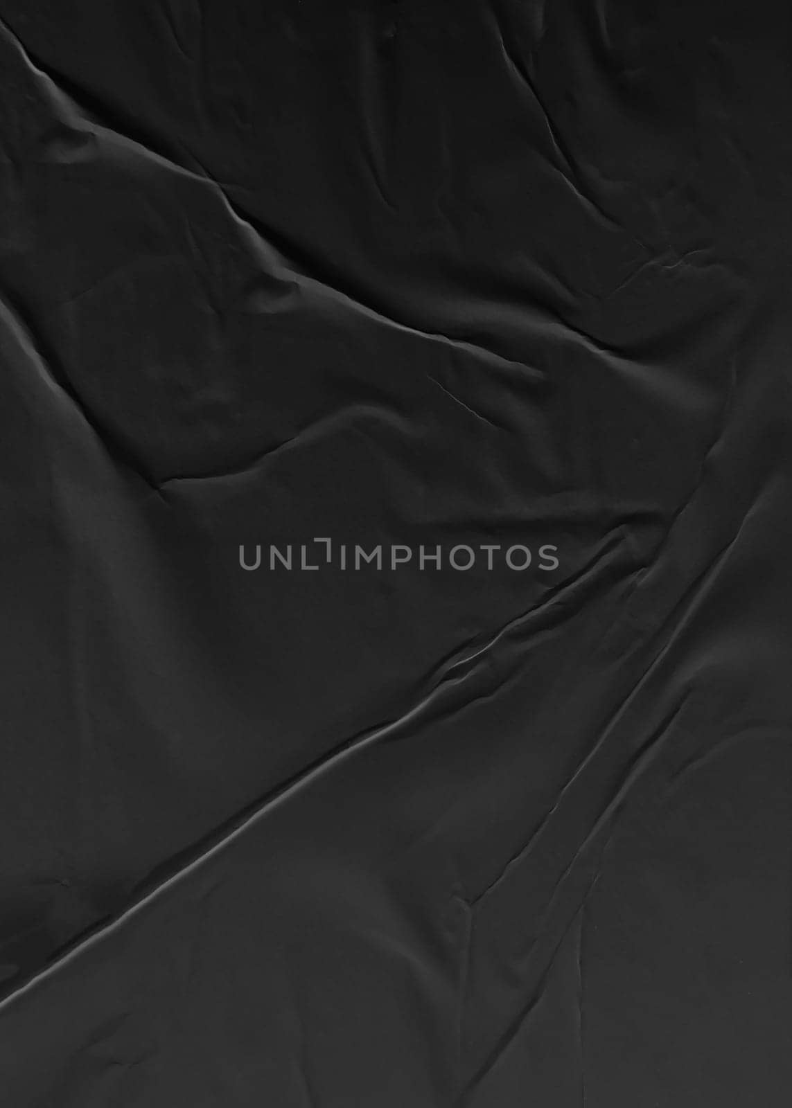 Background texture of crumpled black vertical paper