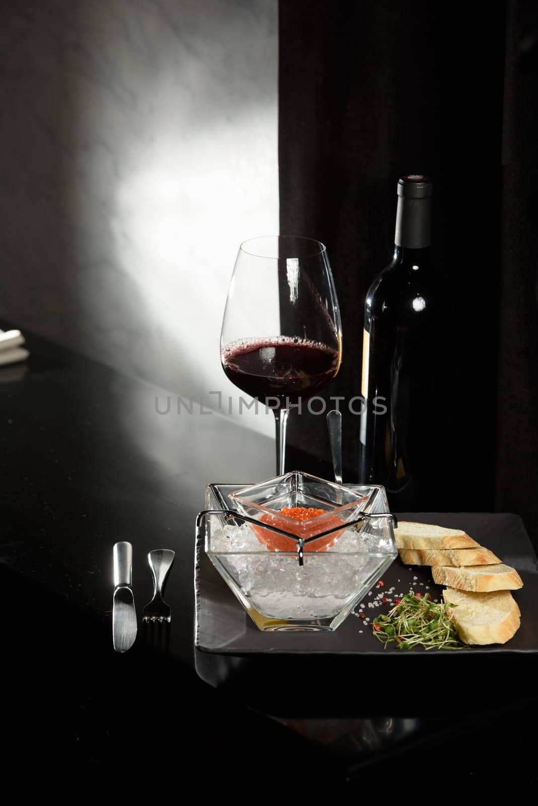 salmon fish caviar, on ice, with croutons, lemon, on a transparent dish, on a dark background by Ashtray25