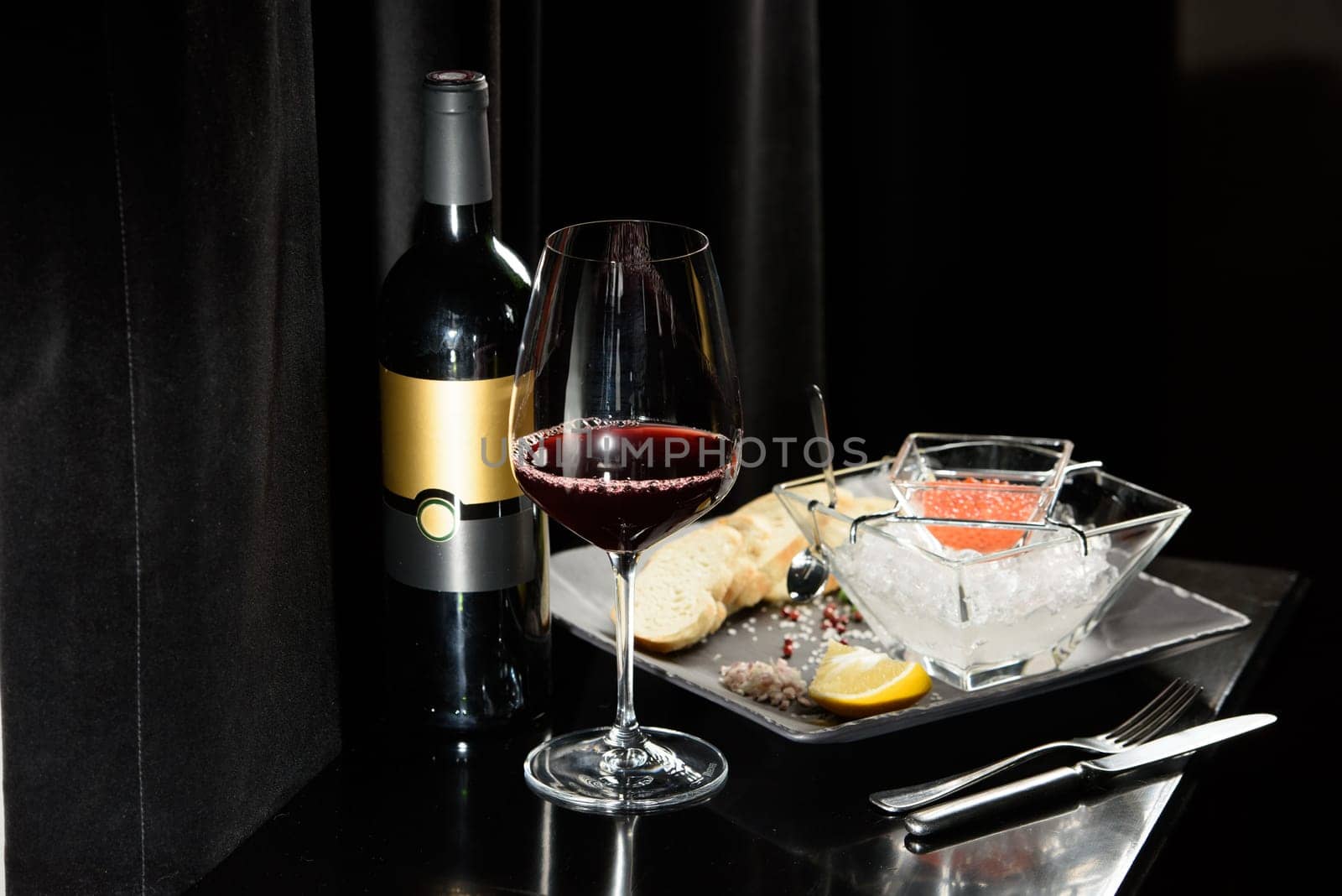 salmon fish caviar, on ice, with croutons, lemon, on a transparent dish, on a dark background by Ashtray25