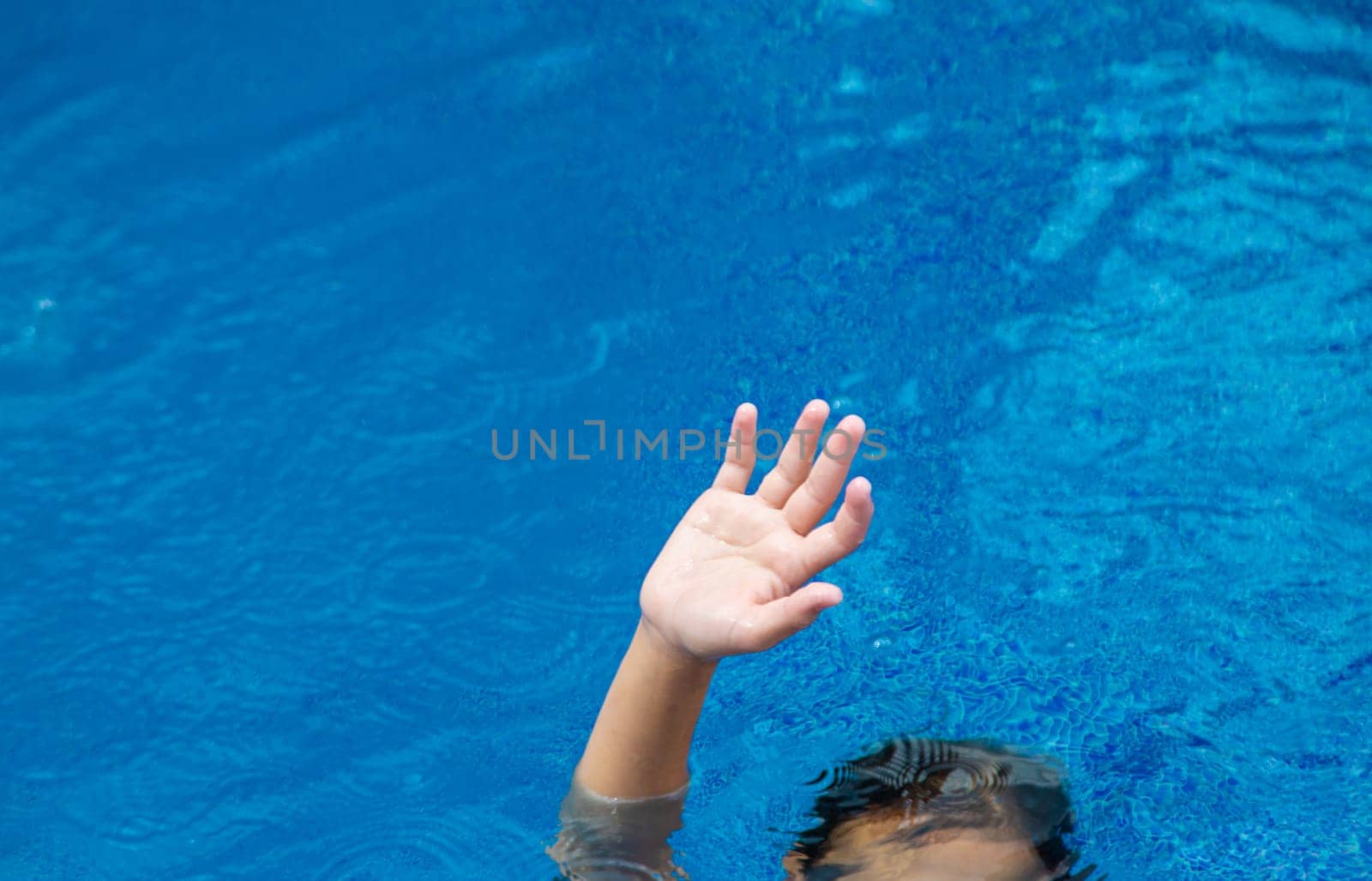 The child drowns in the water. Selective focus. Kid.