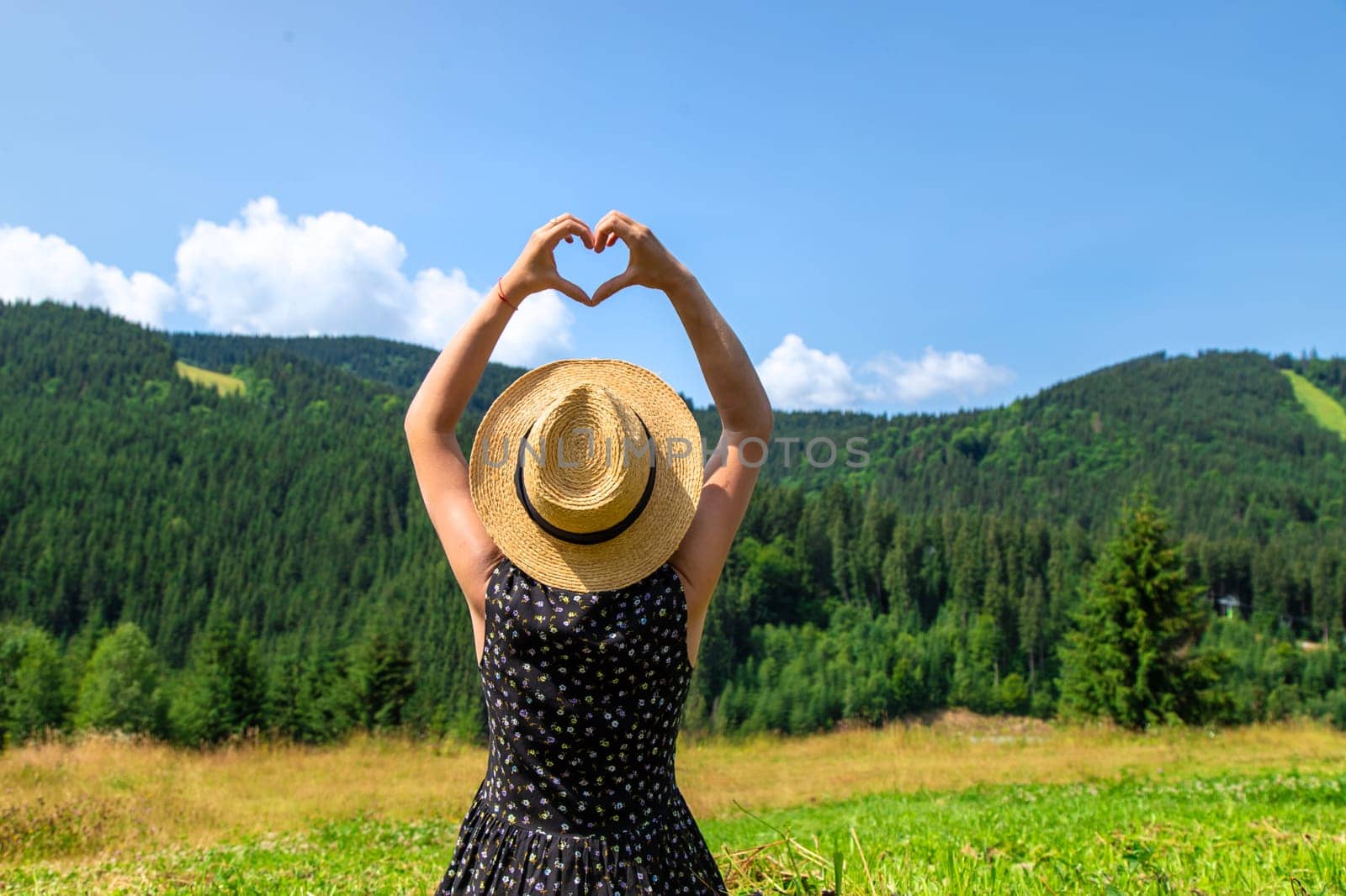 A woman in the mountains admires nature. Selective focus. Nature.