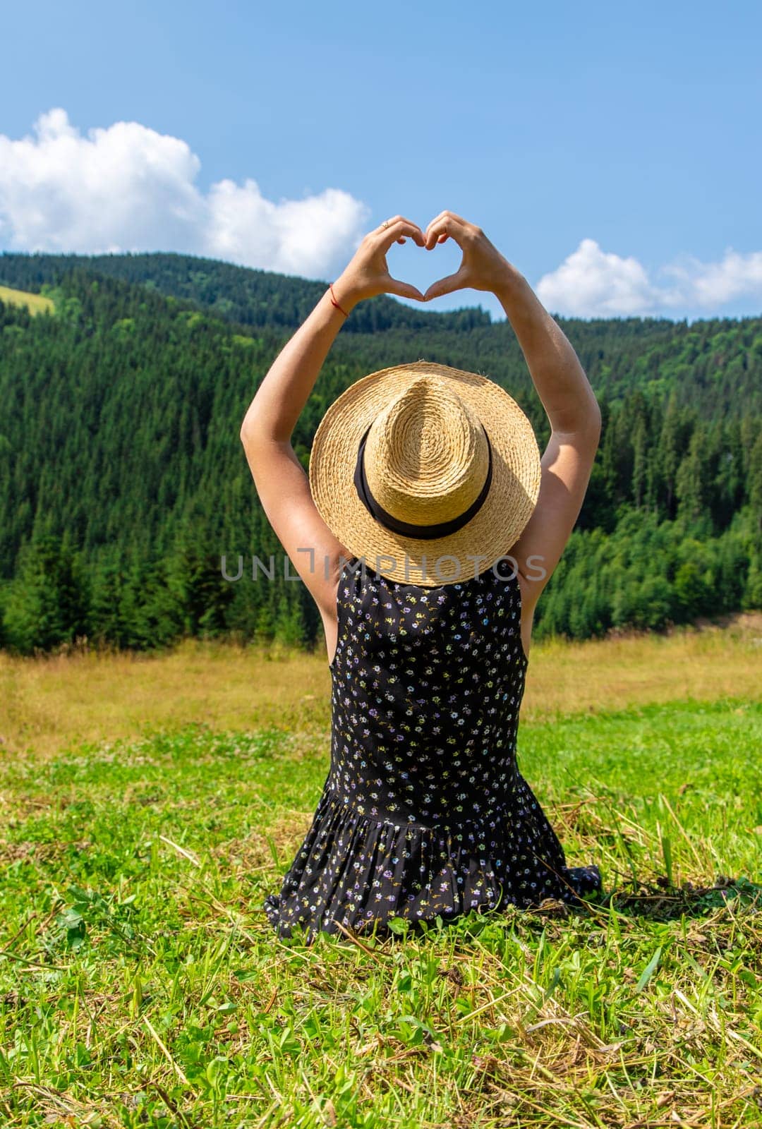 A woman in the mountains admires nature. Selective focus. by yanadjana