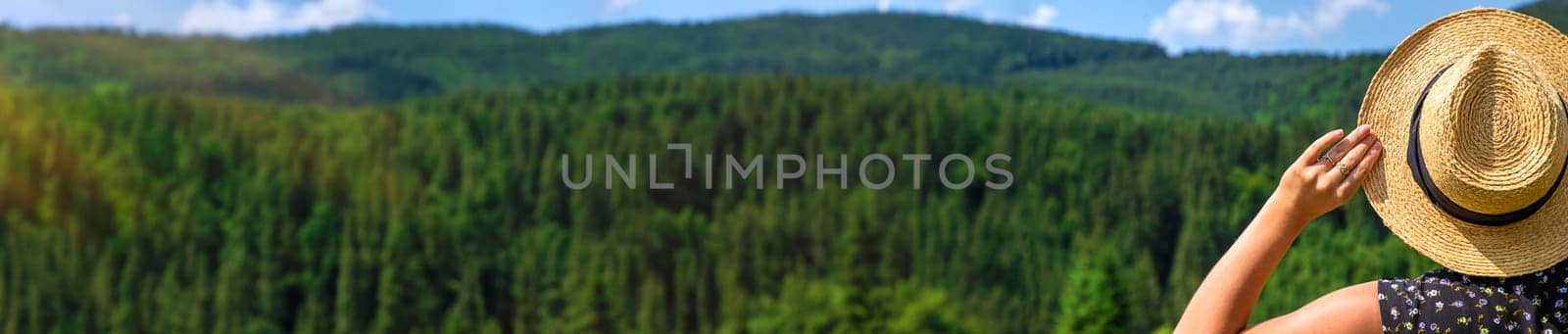 A woman in the mountains admires nature. Selective focus. by yanadjana