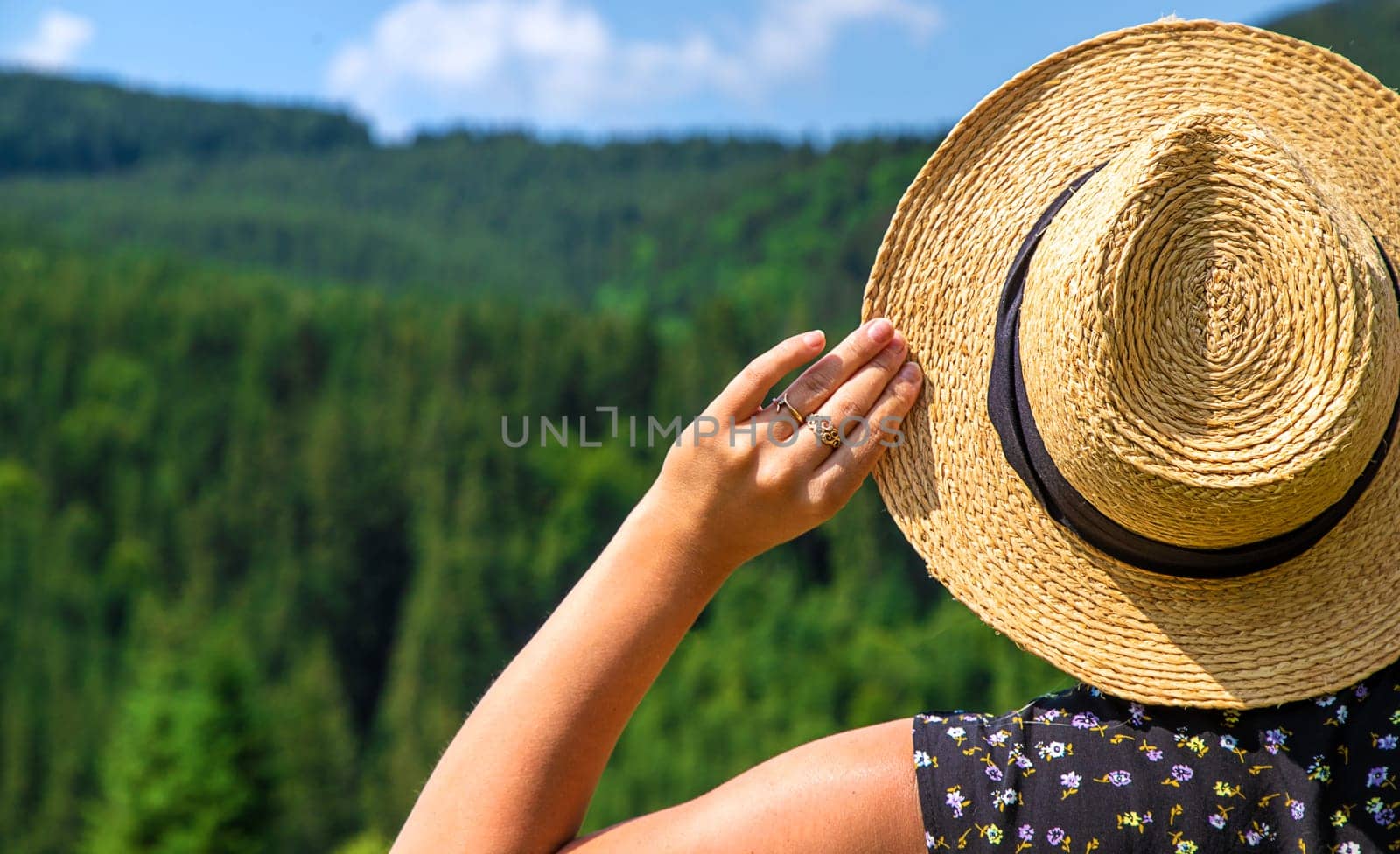 A woman in the mountains admires nature. Selective focus. Nature.