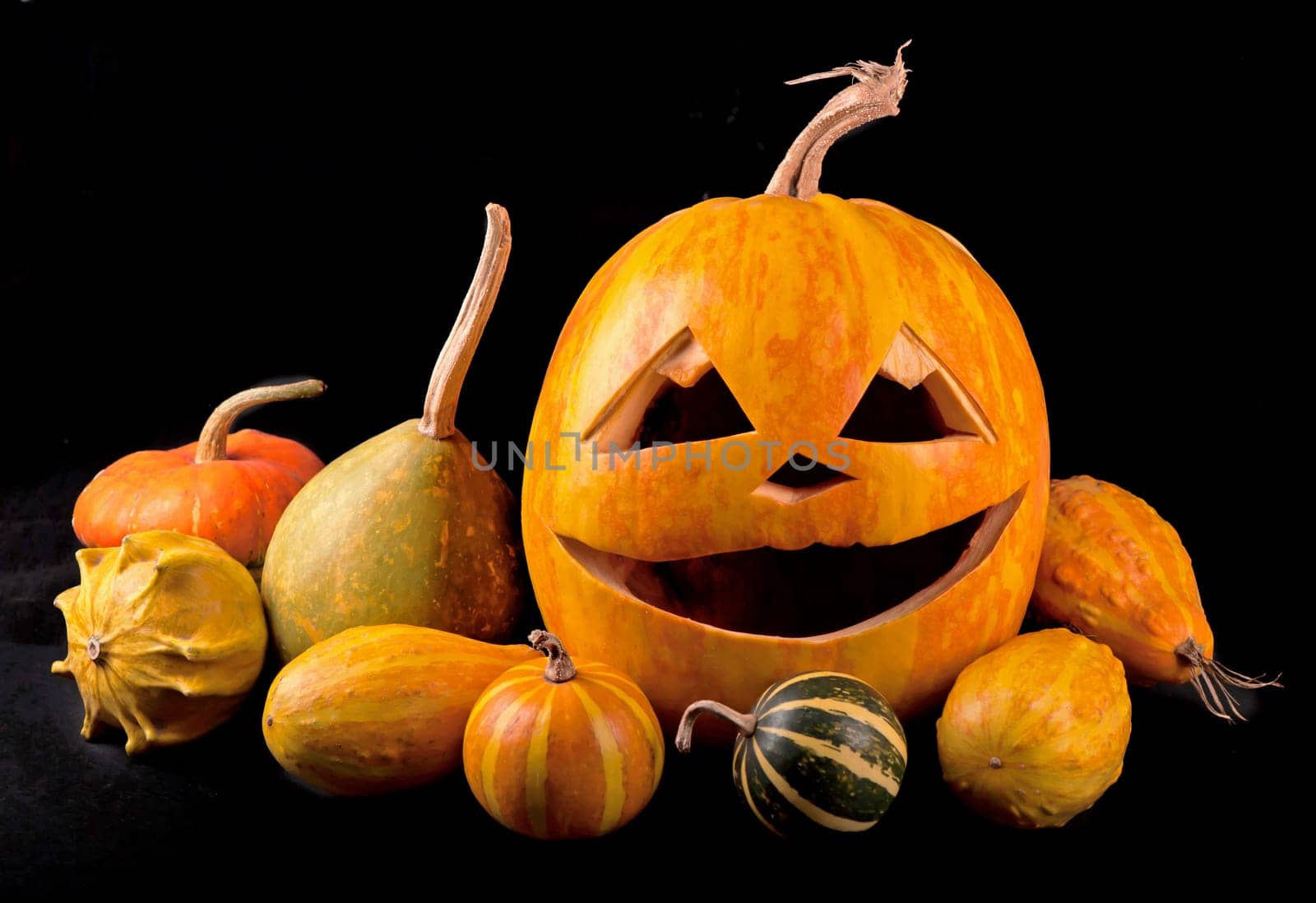 Scary Halloween pumpkins isolated on a black background. Scary glowing faces trick or treat by aprilphoto