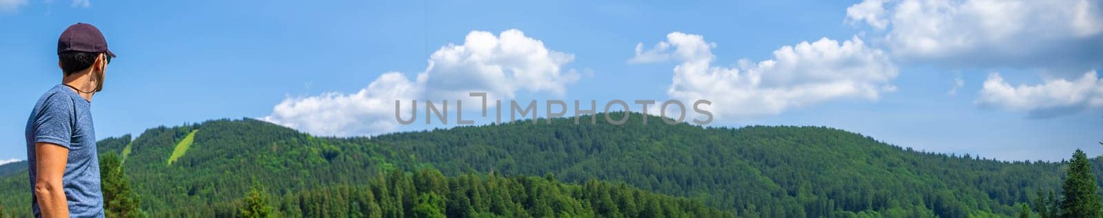 A man in the mountains looks. Selective focus. Selective focus. by yanadjana