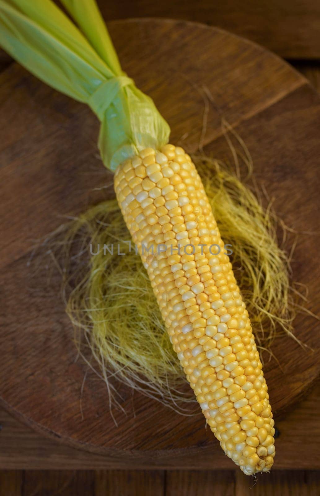 corn cob. Fresh corn on the cob on a rustic wooden table, close up by aprilphoto