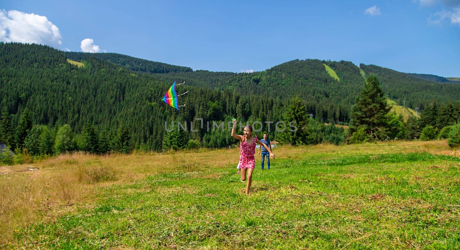 A family flies a kite in nature. Selective focus. by yanadjana