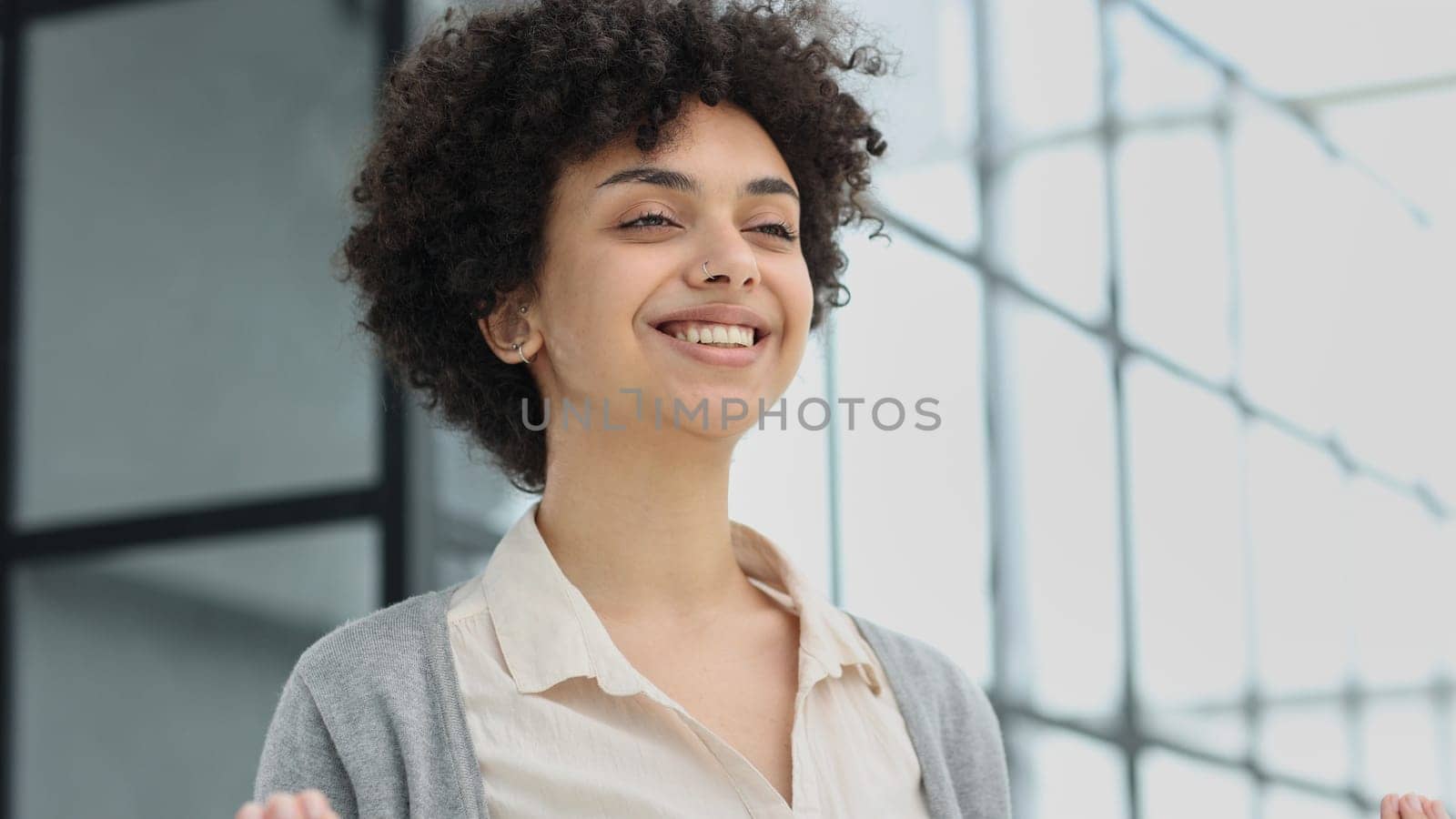 girl in the office smiles expresses success and leadership is thinking about success.