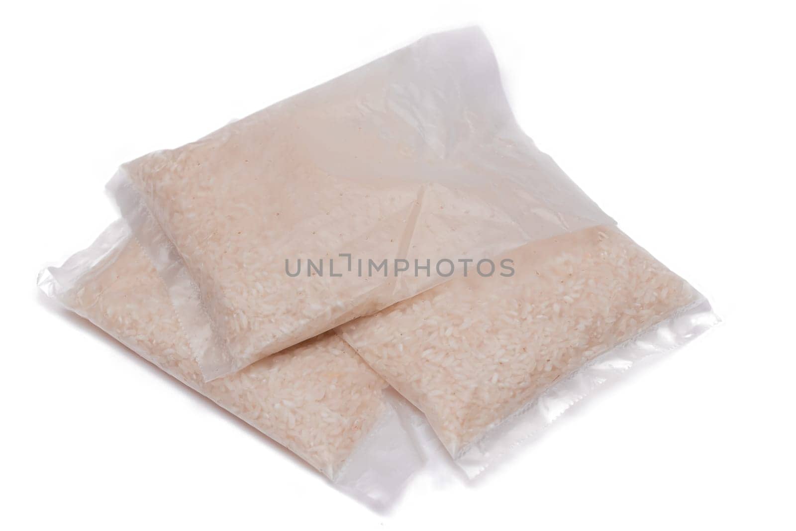 A Plastic Bags of White Long Grain Rice - Isolated on White Background. Small Transparent Packages with Dry Rice - Isolation