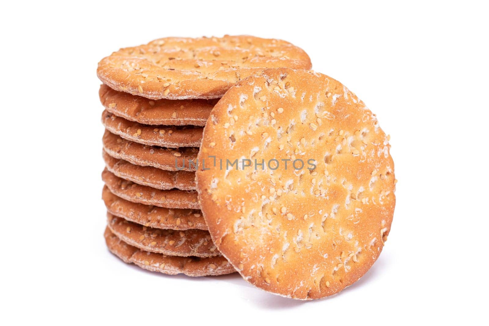 A Stack of Round Salt Crackers with Sesame Isolated on White Background by InfinitumProdux