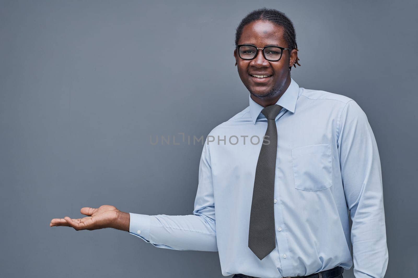 young african american man surprised showing his hand to the side.