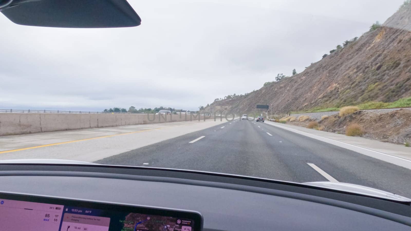 Los Angeles, California, USA-December 4, 2022-POV-Driving along Highway 101 near Rincon Beach, California, amidst a gloomy, cloudy winter day.