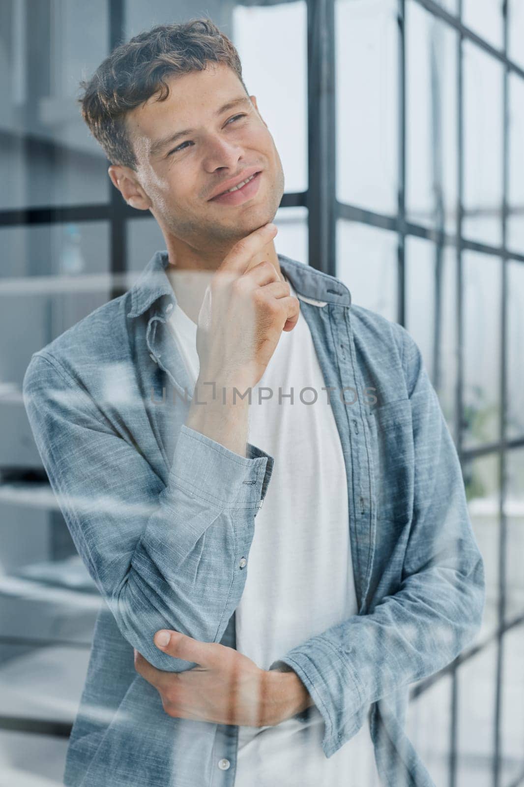 young man in office. thought with a smile