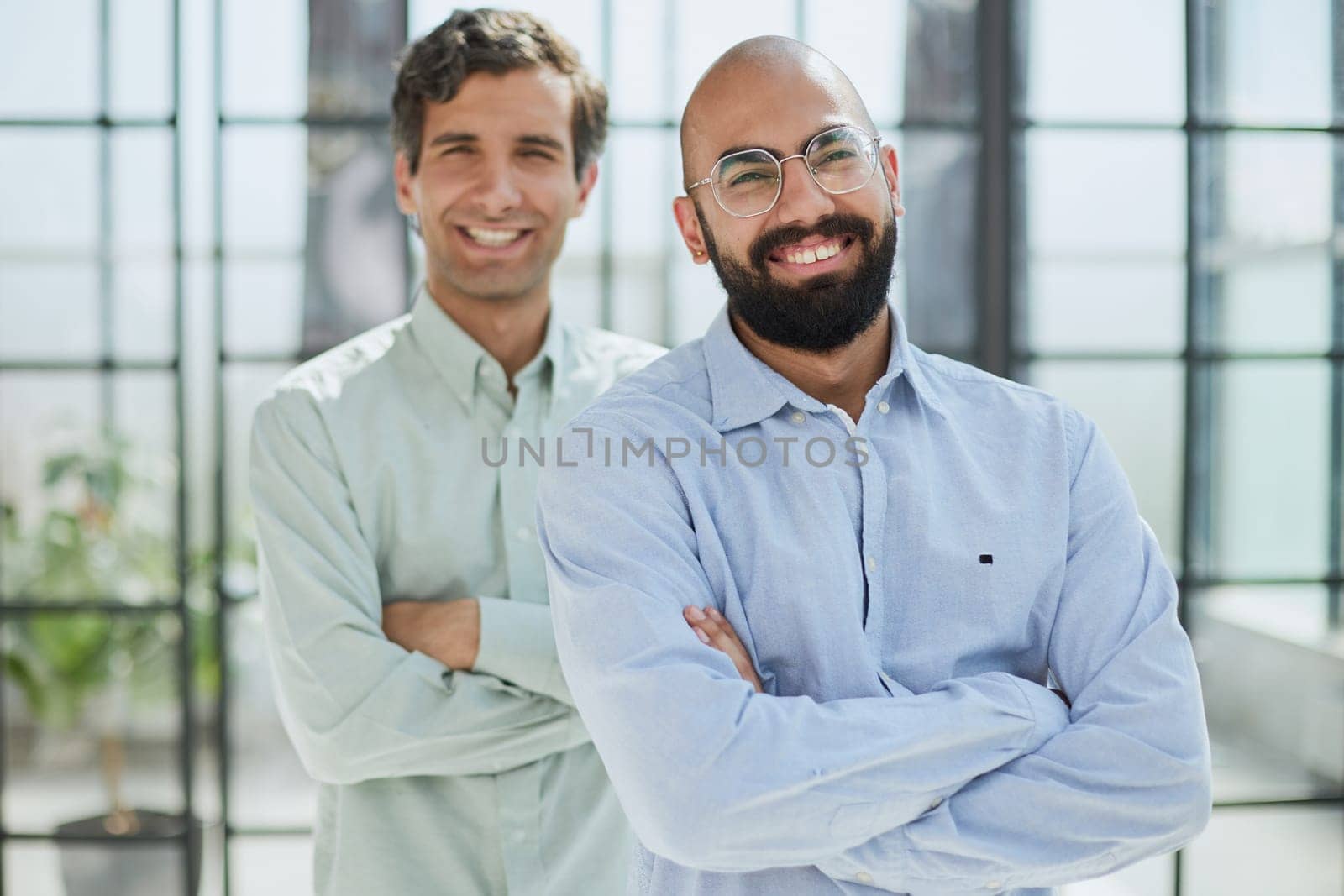 two smiling businessmen in the office by Prosto