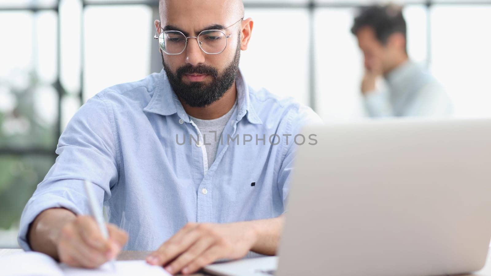 man working on the table with laptop in a new office