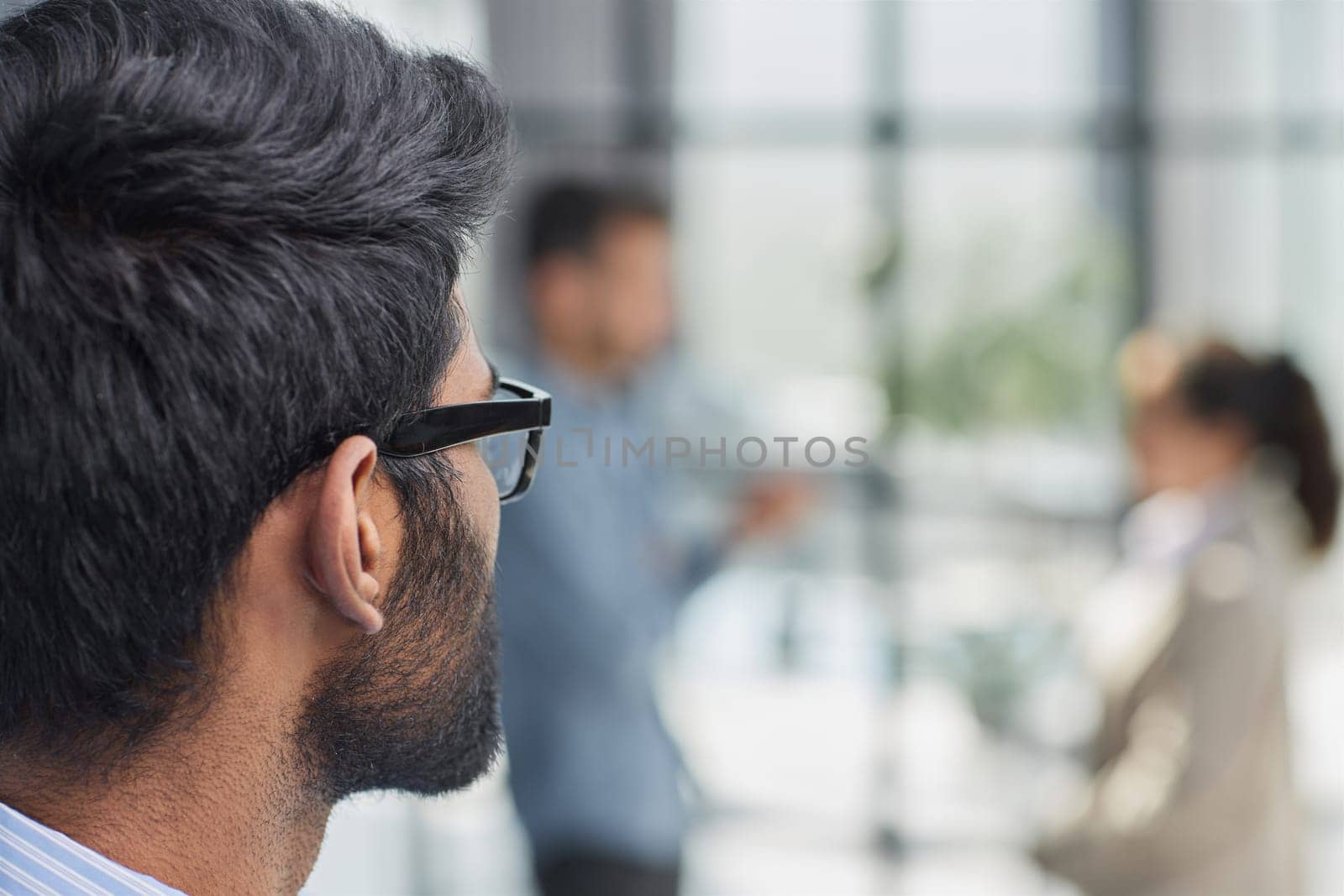 concentrated businessman with beard wearing glasses portrait