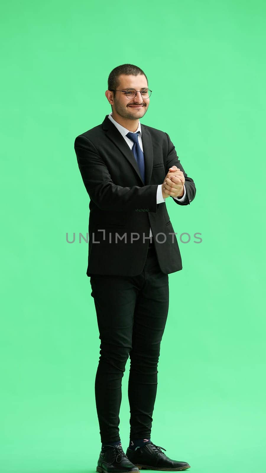 full-length portrait of a young man. standing isolated on green background by Prosto