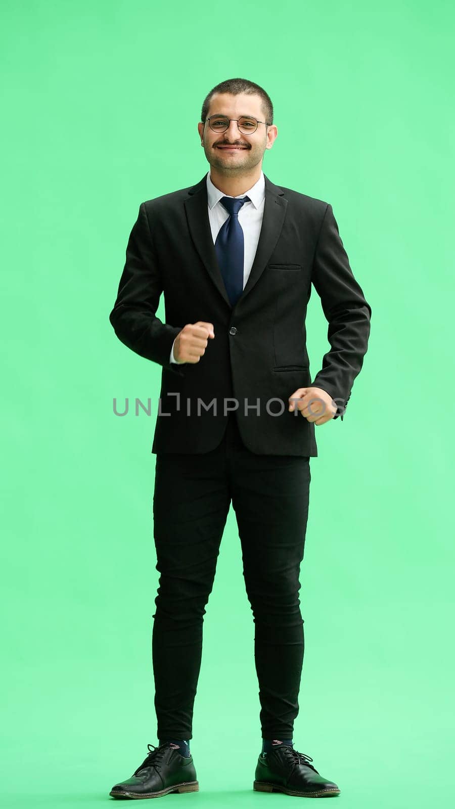 full-length portrait of a young man. standing isolated on green background by Prosto