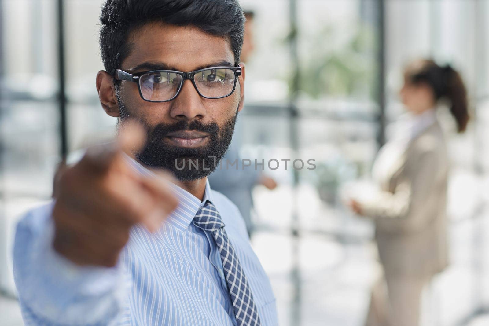 Young handsome businessman pointing at you in the office by Prosto
