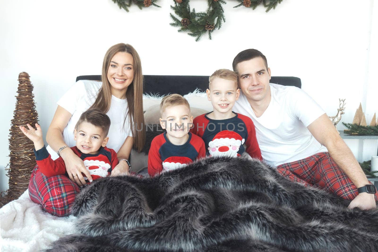 family in the morning waiting for gifts for the New Year , year 2024