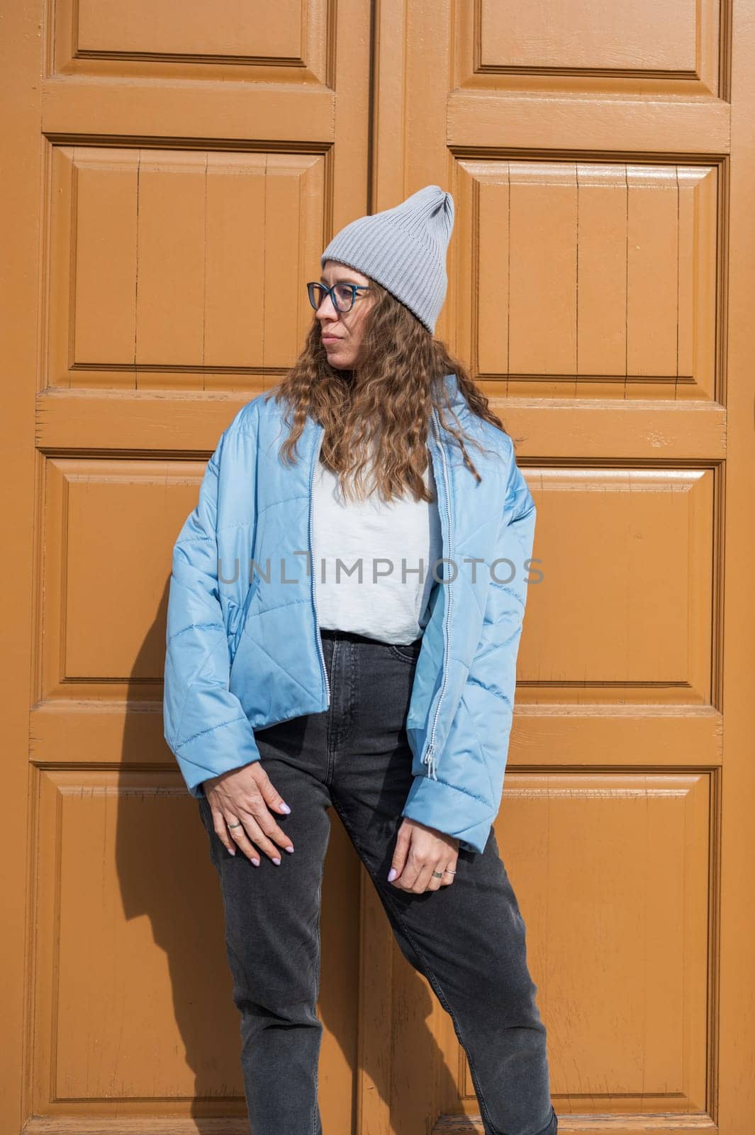 Portrait of a stylish woman in blue jacket. Spring outdoor portrait.