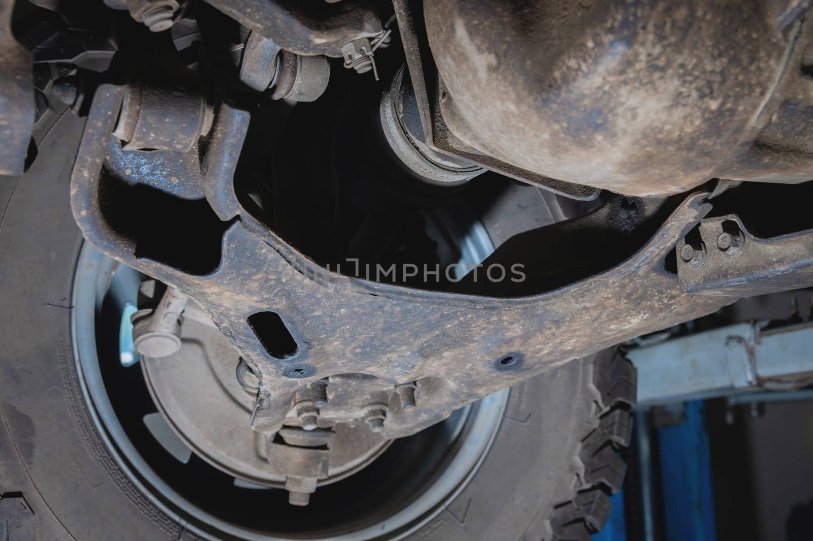 Front suspension. View from below. SUV suspension in dust.