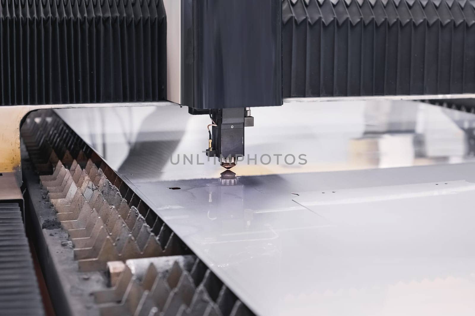 Scene close up, laser cutting machine cuts a metal plate. High-tech sheet metal production process using a laser cutting machine, CNC by yanik88