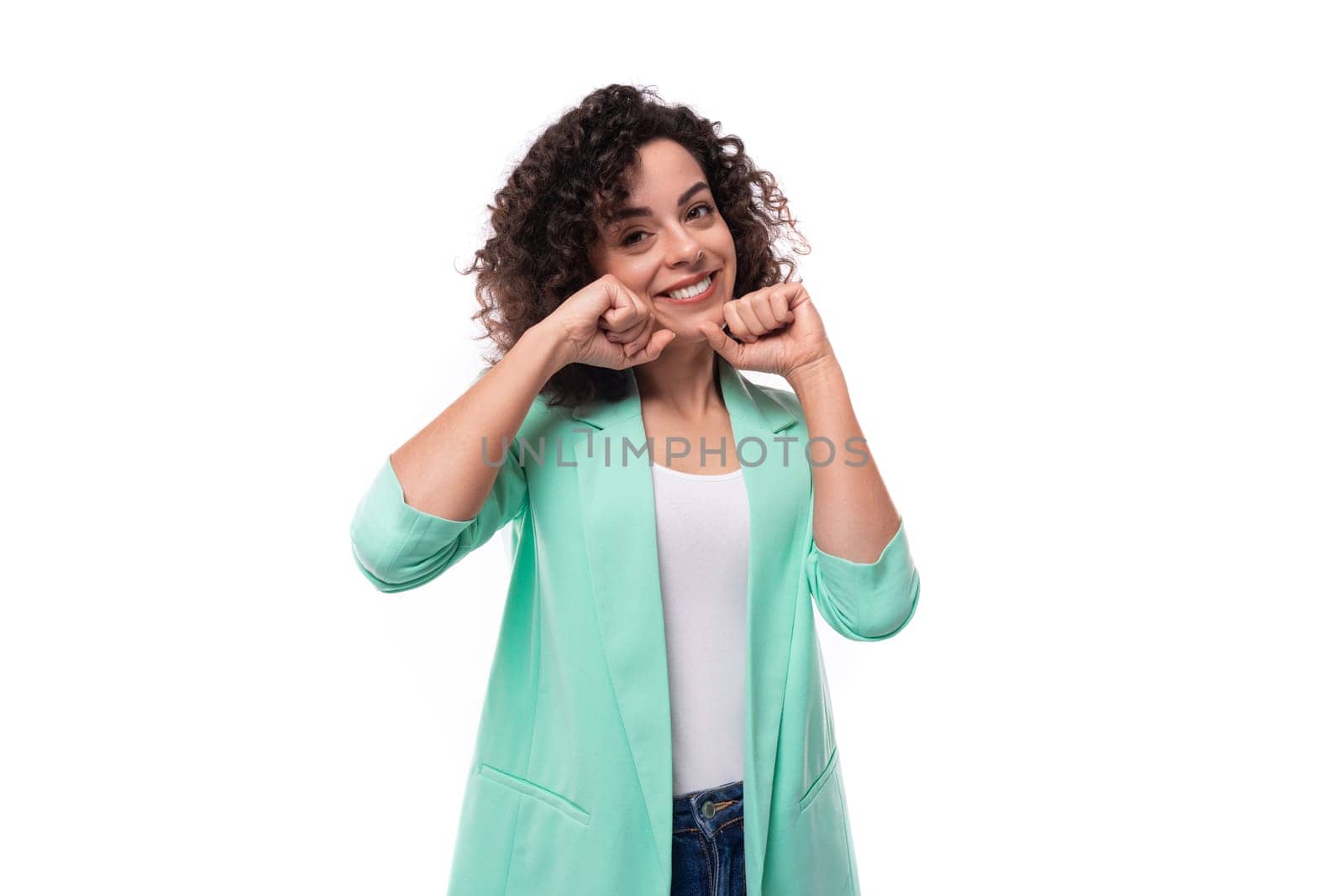 young leader woman with curly black hair dressed in jacket smiling isolated on white with copy space by TRMK