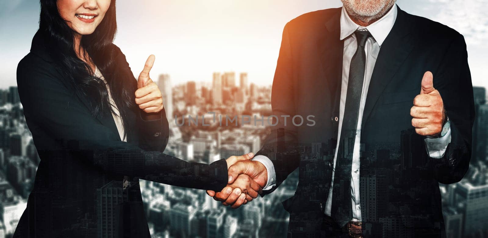 Double exposure image of business people handshake on city office building in background show partnership success of business deal. Concept of corporate teamwork, trust partner and work agreement. uds