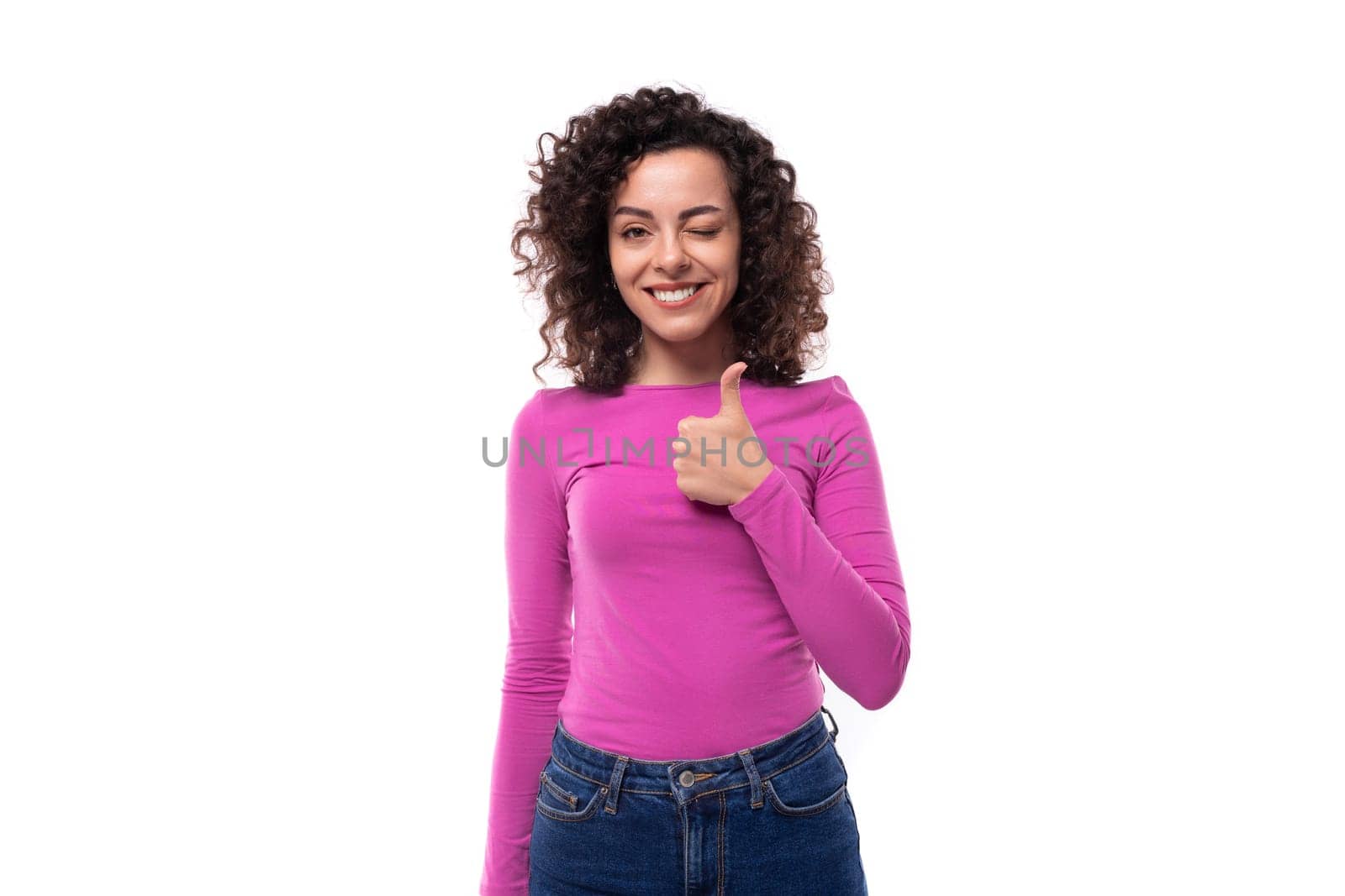 young pretty leader woman with curly black hair is dressed in a lilac jacket on a white background.