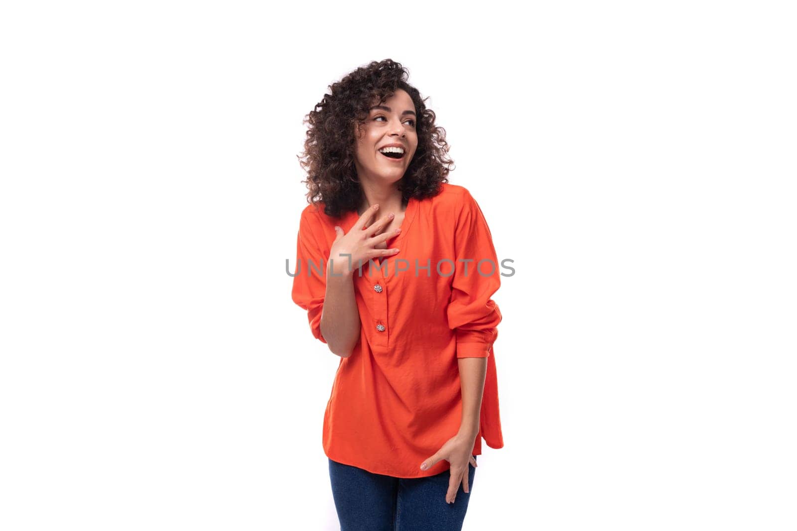 young cheerful caucasian lady with curly hair style dressed in orange shirt by TRMK