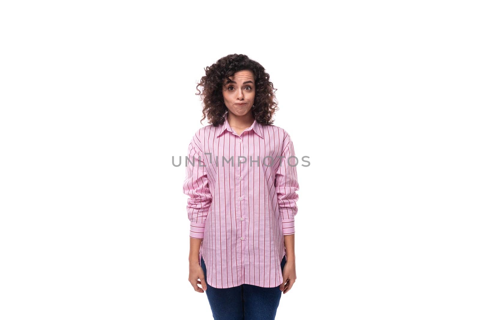 young well-groomed brunette woman in a pink shirt with a grimace isolated on white background by TRMK