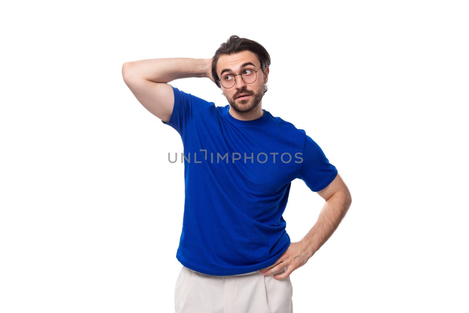 young smart caucasian brunette man with stylish haircut and beard in blue t-shirt thinking about idea and strategy. brainstorm.