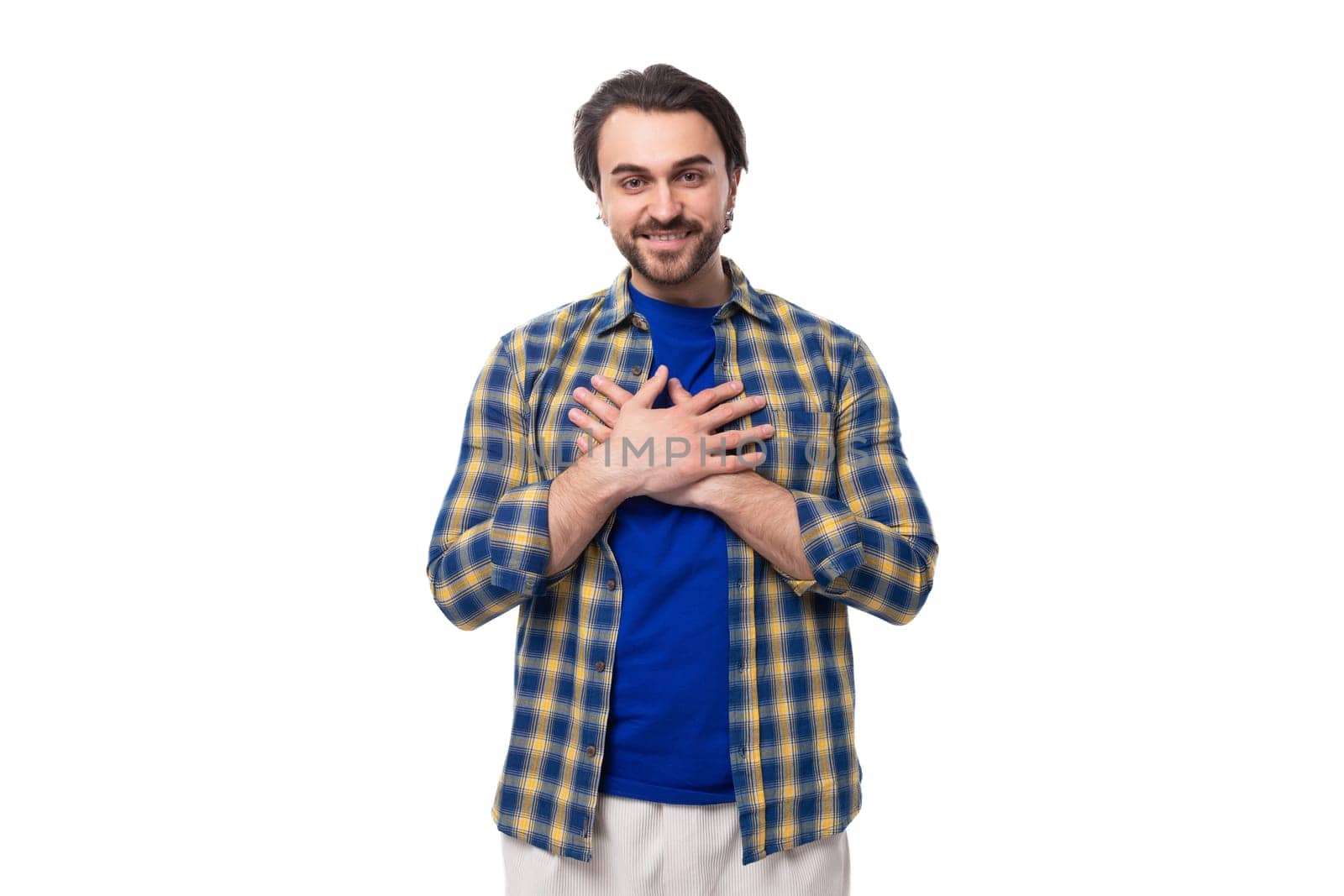 portrait of a pleasant calm young european brunette with a beard dressed stylishly in a shirt.