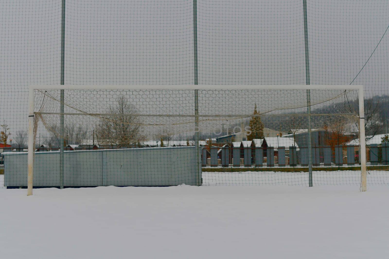 A snow-covered football goal. The concept of the end of the football season, the football league and the end of the sports season by roman_nerud