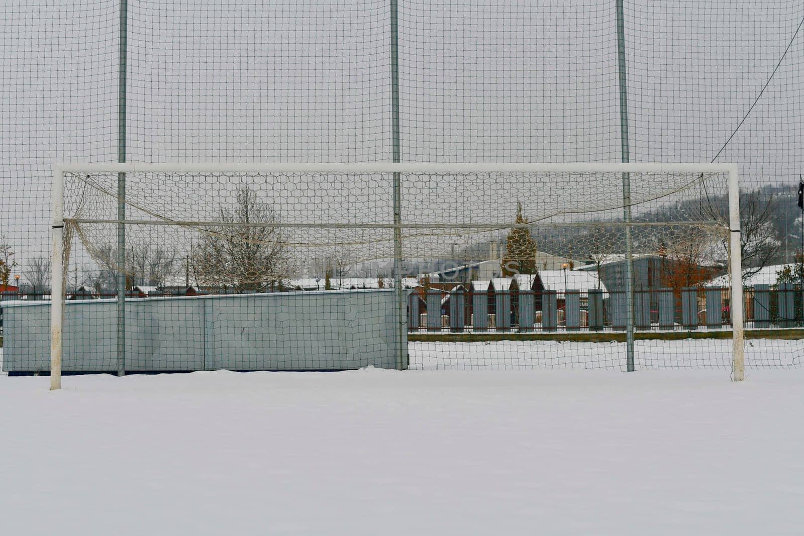 A football goal covered in snow. The concept of the end of the football season and the end of the football league by roman_nerud
