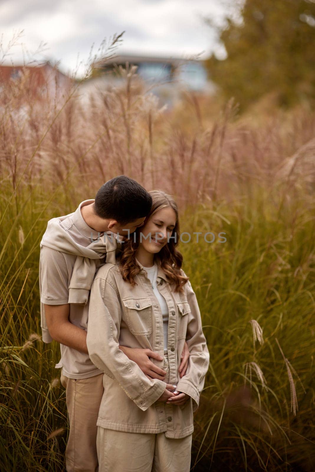 Young Cute Female Hugs Boyfriend. In Autumn Outdoor. Lovers Walking in Park. Attractive Funny Couple. Lovestory in Forest. Man and Woman. Cute Lovers in the Park. Family Concept. Happy Couple.