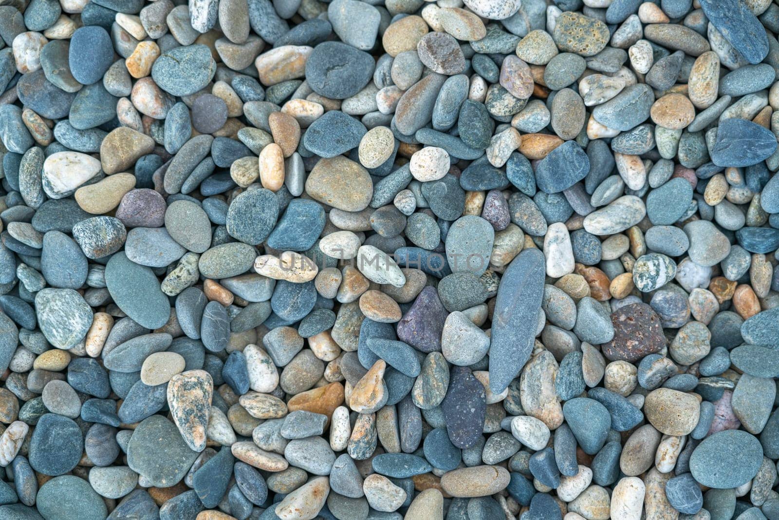 the texture of the pebbles in close-up as a background by roman112007