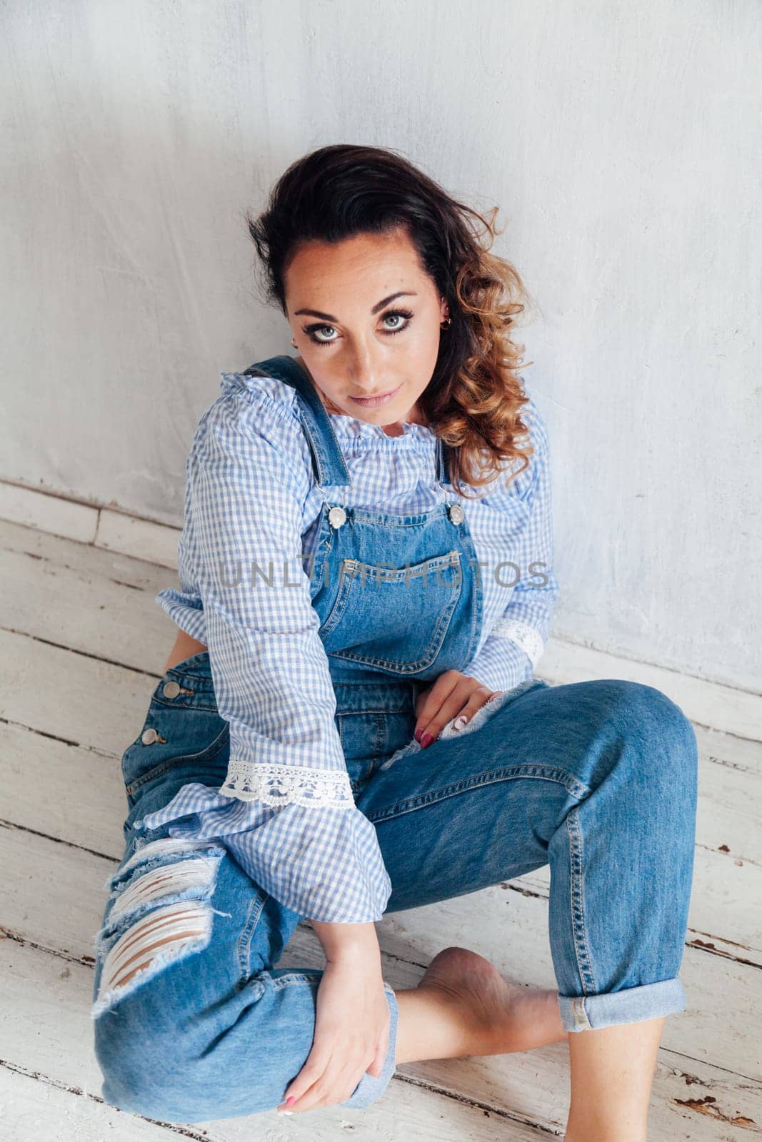 beautiful fashionable woman in denim jumpsuit white by Simakov