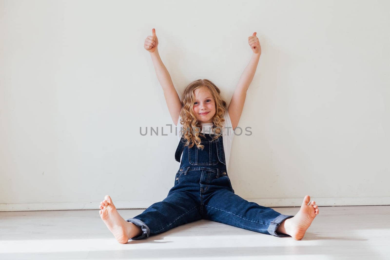 Portrait of a blonde girl in a denim jumpsuit