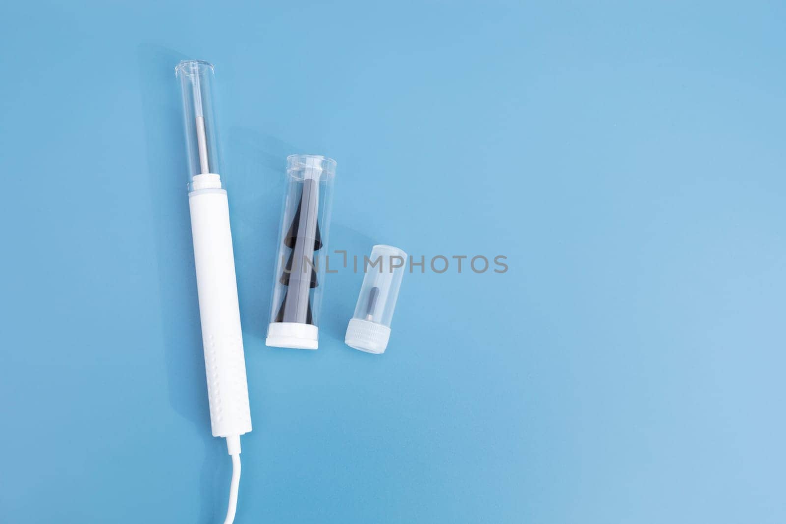 Top View Ear Scope For Wax Removal Tool. Digital Otoscope, Earwax Cleaner With Gyroscope, Camera, Light. Cleaning Ears Device Connected to Smartphone. Ear Cleaning Technology. Copy Space, Mockup.