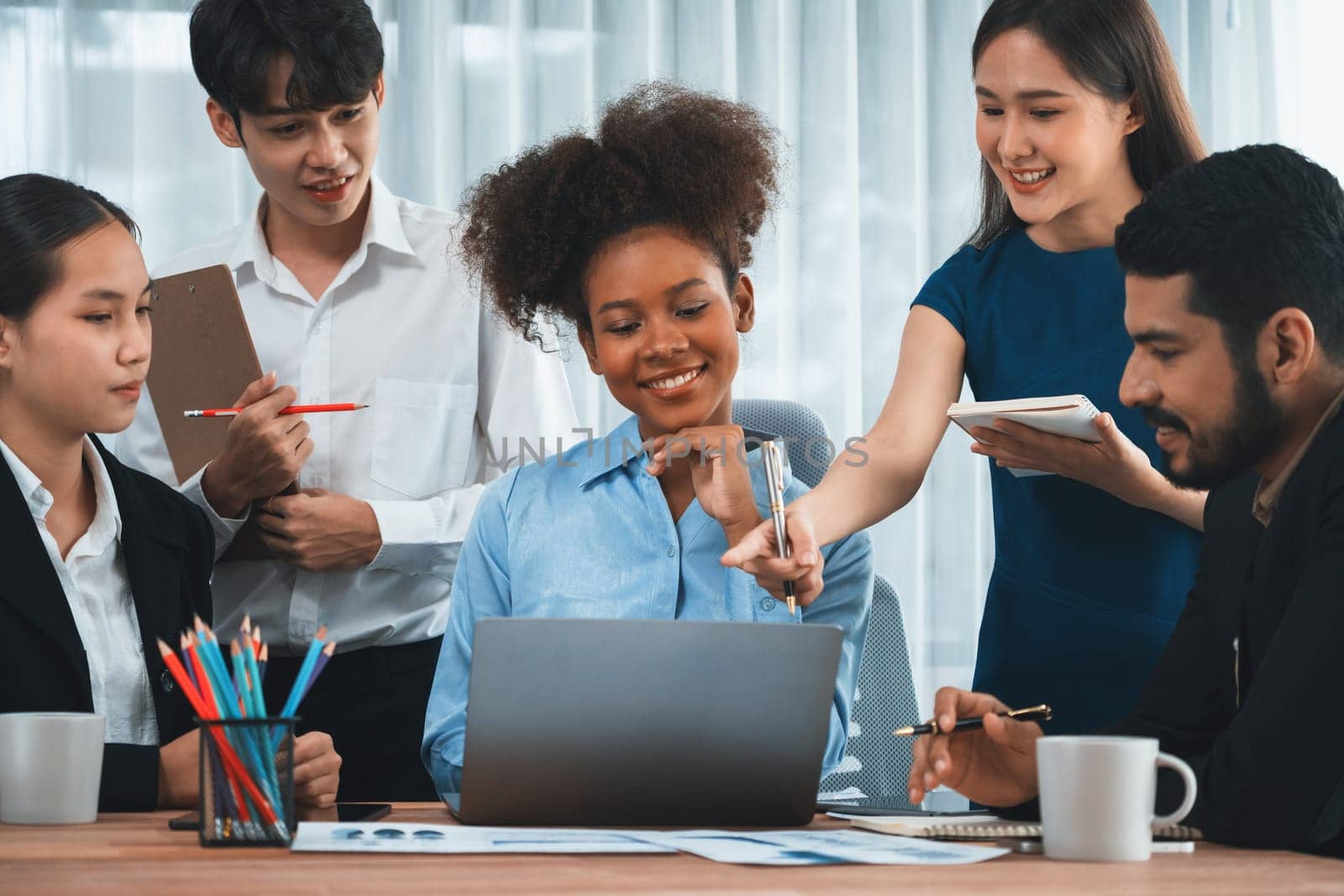 Happy diverse business people work together, discussing in corporate office. Professional and diversity teamwork discuss business plan on desk with laptop. Modern multicultural office worker. Concord