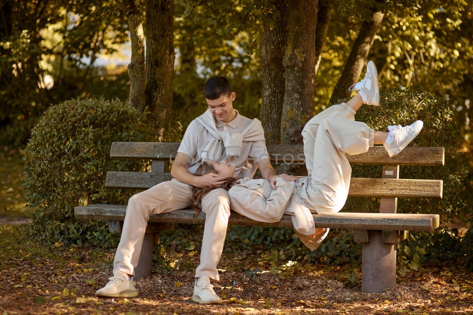 Young Cute Female Hugs Boyfriend. In Autumn Outdoor. Lovers Walking in Park. Attractive Funny Couple. Lovestory in Forest. Man and Woman. Cute Lovers in the Park. Family Concept. Happy Couple.