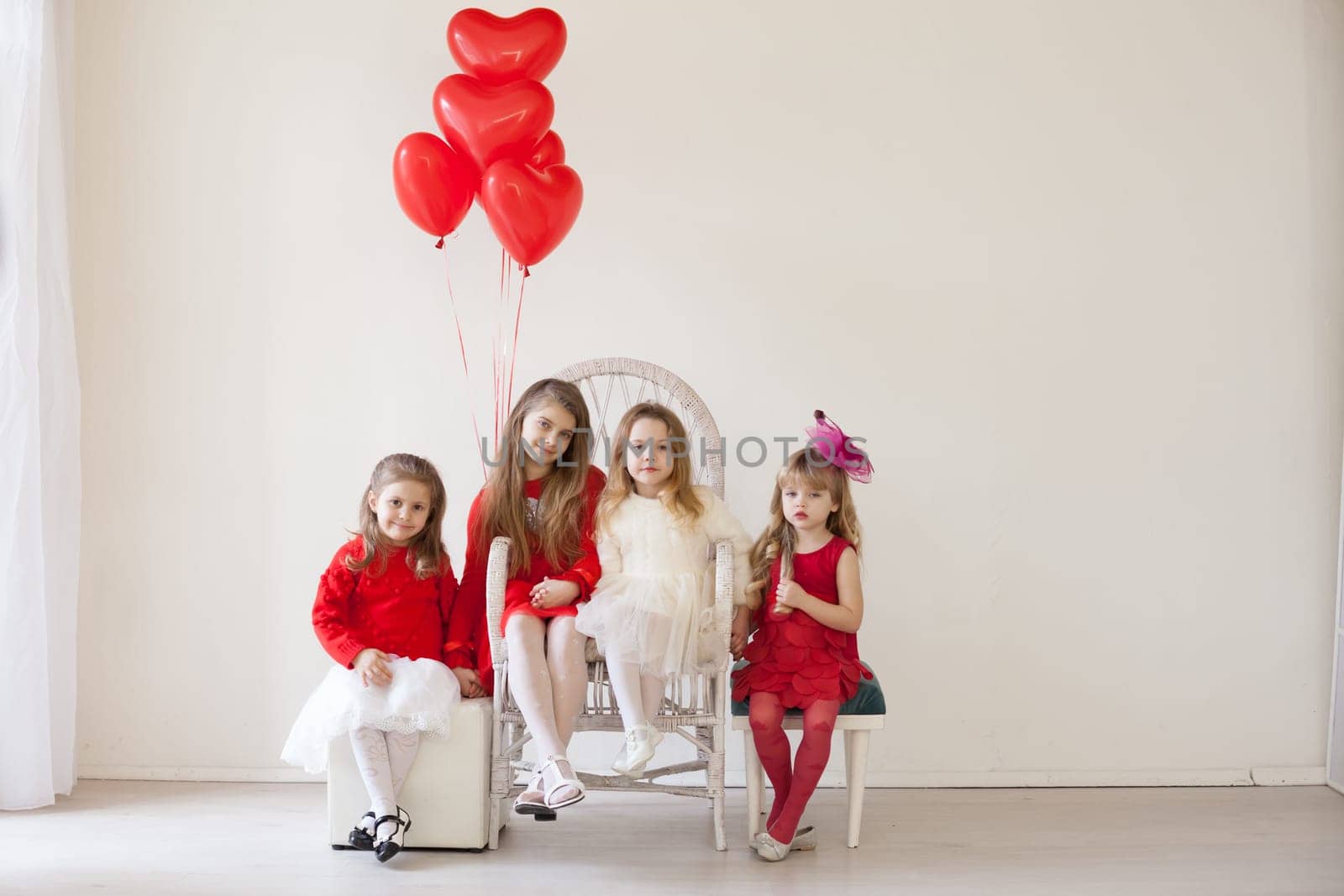 Girls with red heart-shaped balloons on birthday